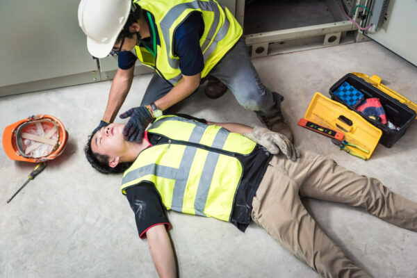 Injured worker being properly attended to at site of workplace accident